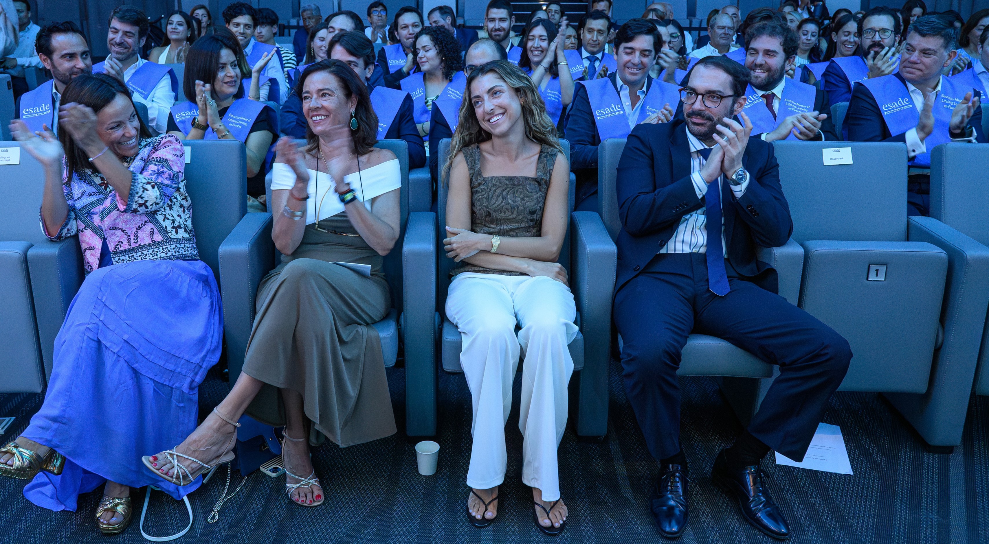 A spontaneous round of applause for Finance Programme Manager Mari Carmen Donaire from the Executive Master in Finance participants behind her.